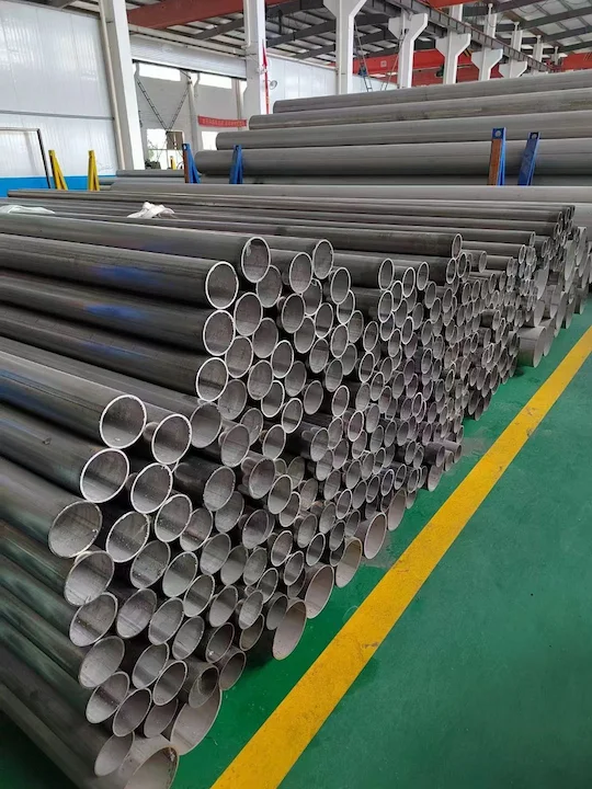 Stainless steel pipes stacked in a warehouse